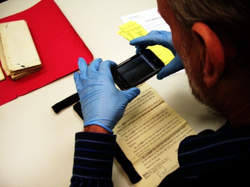 Reader taking photo of record